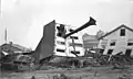 The John Schultz house in Johnstown, Pennsylvania after the flood. Skewered by a huge tree uprooted by the flood, the house floated down from its location on Union Street to the end of Main. Six people, including Schultz, were inside the house when the flood hit; all survived.