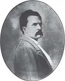 Oval black-and-white portrait of a man with a moustache