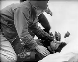 Joseph T. O'Callahan gives last rites to an injured crewman aboard Franklin on 19 March 1945