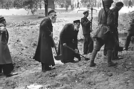 A Polish Army soldier and civilians including Orthodox Jews defending their capital city against Nazi Germany