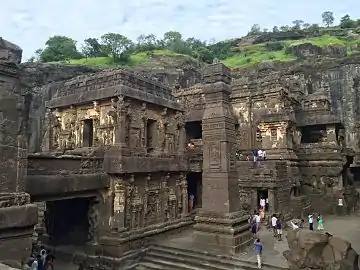 Tourists visiting a temple cut in rock