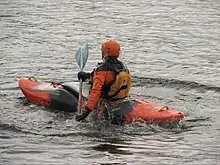 Kayaker coming up from a roll on flat water