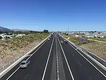 View of road lanes from over bridge.