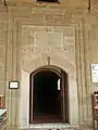 The entrance door of the mosque and its inscription