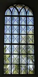 Post-Modern leadlighting combining traditional diamond pane form with the squareness of an iron armature and the arch of a church window in a design of great precision and subtlety. Karlstad Cathedral, Sweden.