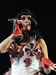 Perry performing in a dress decorated with peppermint swirls