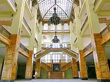 Atrium of a large, multilevel building of a defunct department store flagship. Note the damaged ceiling in the background