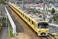 The "Yellow Happy Train" livery with original silver doors in March 2017