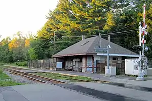 A small wooden railway station in a rural area