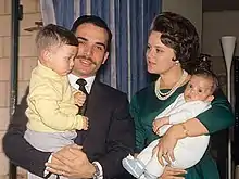  A young King Hussein and Princess Muna, holding their two young sons