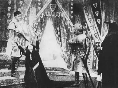 The Lamentation Scene: Act 2, Scene 1, corresponding to Act 3, Scene 4 in the original play. Lady Constance (front left) laments the capture of her son, Prince Arthur, as Lewis (rear left), Cardinal Pandulph (front right), and Philip of France (rear right) look on.