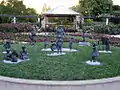 Imelda Roche life size bronze sculpture with her grandchildren as centrepiece of rose garden in Hunter Valley Gardens by Linda Klarfeld