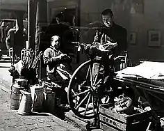 Scissors grinder ("Afilador") with grinding cart in Oviedo in Spain, about the beginning of the 20th century.