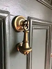 The brass knocker on the lodge of Coombe House.