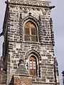 The tower with the balustrade and coats of arms