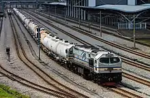 A KTMB Class 26 is resting with its cement train at Ipoh station.