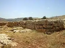 Colored photograph showing a rectangular stone structure