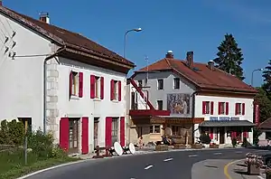 Hotel Arbez in La Cure.  The border runs lengthwise through the two buildings, passing just to the left of the mural.  The mural and everything to the right of it lies in Switzerland; France lies to the left.