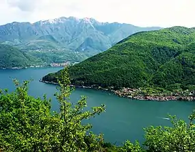 A wooded mountain and a lake.