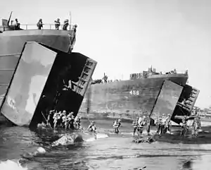 Australian troops disembarking from American Landing Ships, Tank (LST), including LST-456, at Red Beach