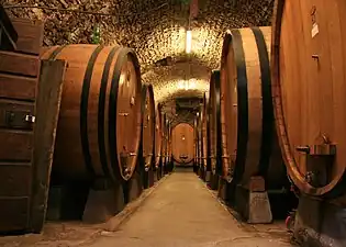 Oak barrels in a winery in Chianti, Italy.