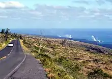 Lava from Puʻu ʻŌʻō flows through subsurface lava tubes until it meets the ocean, creating the steam plumes seen in the distance from Chain of Craters Road