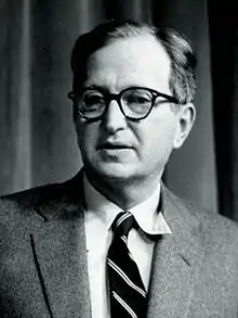 Head shot of a man in a suit wearing glasses