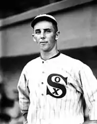 A black and white portrait photograph of a baseball player in a white uniform with "Sox" written on the chest