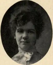 A young white woman with dark hair in an updo, in an oval frame