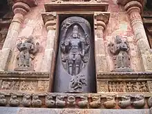 Sculpture of a lingam with Shiva emanating out of it with Vishnu on the right and Brahma on the left