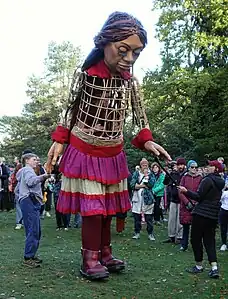 Puppet with three visible puppeteers