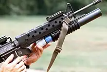 Loading an M203 attached to an M16A1 with a practice round