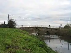 Stone bridge over water.