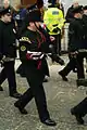 Riflemen in dark green No. 1 dress uniform; bugler (foreground) in full dress busby.