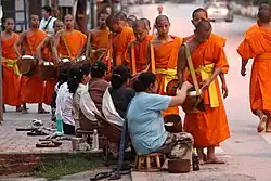 Image 14Monks gathering morning alms (from Culture of Laos)