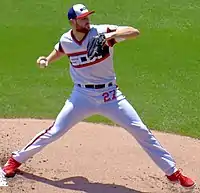 A man in a white baseball uniform