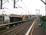 Lysaghts railway station, in Australia, with two side platforms and a footbridge connecting them.