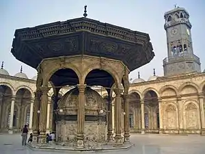 The courtyard (sahn) of the mosque and the clock tower.