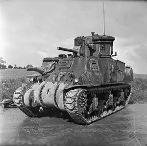 A Canal Defence Light turret fitted to an M3 Grant tank; the CDL turret is fitted with a dummy gun