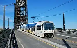 A light-rail train crossing a bridge