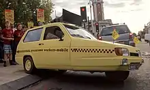 Striking staff outside the Ritzy Cinema with the Precarious Workers Mobile, a customised car used to campaign for workers' rights