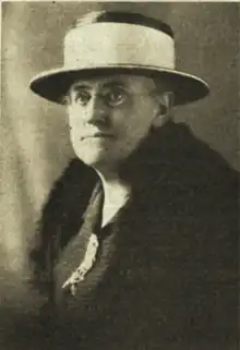 Portrait of older woman wearing a hat.