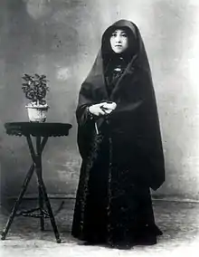 Macanese senhora wearing the traditional Macanese dress, the dó