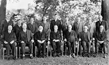 A group of men pictured in two rows, with the front row seated