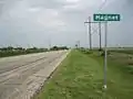 Magnet sign and broadcasting tower are on Highway 60.