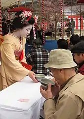 Maiko Satohana from the Kamishichiken district of Kyoto serving tea at Baikasai, the plum blossom festival, at Kitano Tenman-gū