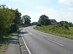 Main Street (the A6006) entering the hamlet from the Nottinghamshire side