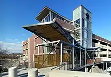 A short footbridge leading to a brick-faced parking garage