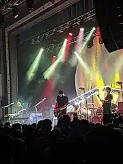 Portrait photo of Manchester Orchestra, performing live in concert, at Roxian Theatre, in Pittsburgh, Pennsylvania. Photo shows members of the band on stage with audience in foreground