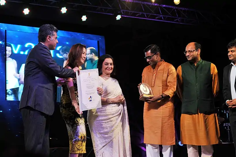 Manish Tewari and the Hollywood actress Michelle Yeoh presenting the Special Centenary Silver Peacock Award to Kamaleshwar Mukherjee.jpg